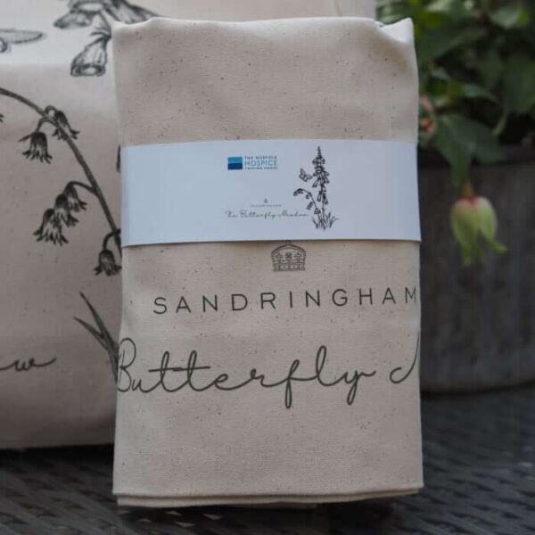 Bag with Sandringham in writing and a butterfly with some flowers